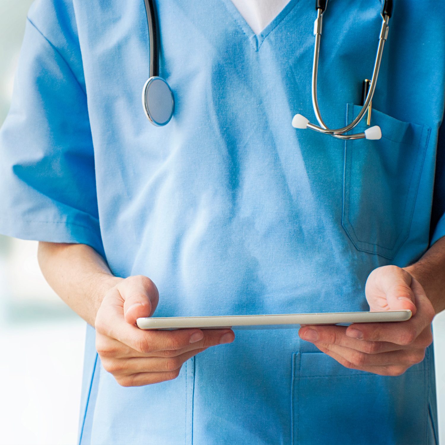 healthcare assistant holding tablet